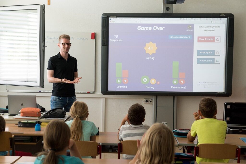 teacher in front of class - Key Stage Learning logo provider of online tuition and training